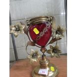 BRASS VASE WITH FOLIATE MOULDING AND RED GLASS HEART SHAPED RESERVOIR
