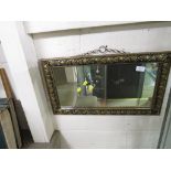 RECTANGULAR WALL MIRROR IN A BRASS CLAD FRAME