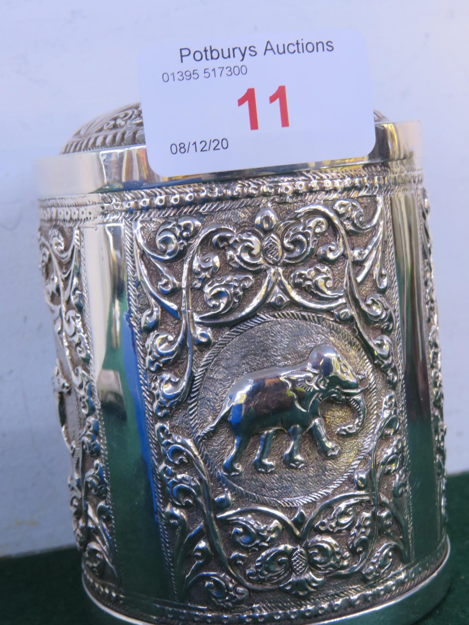 WHITE METAL CYLINDRICAL BOX WITH LID, DECORATED WITH ANIMALS AND FOLIAGE, THE BASE ALSO