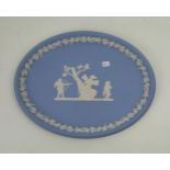 A Wedgwood blue jasperware oval plaque: 25cm.