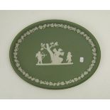 A Wedgwood green jasperware oval plaque: 25cm.