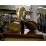 Brass propeller mounted on wooden plinth