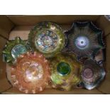 A collection of darker coloured carnival glass item to include: commemorative plates, footed