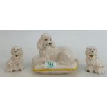 Royal Doulton Dogs: Royal Doulton large white Poodle on cushion and a pair of small spaniel dogs. (