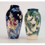 Moorcroft Foxglove and Butterfly Vase and Angels Trumpet Vase: Foxglove vase on a dark blue