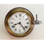 Wempe Chronometerwerke Hamburg brass Ships clock: On a wood base with striking bell movement,