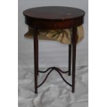Early 19th century Sewing Table: Inlaid mahogany oval table measuring 53cm x 40cm x 72cm high.