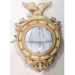 20th century convex Wall mirror: In gilt ball frame with eagle finial, height 84cm.