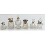 Six cut glass & silver mounted Scent bottles: Heights between 5cm & 11cm. Two with dented tops.