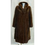 A dark brown Mink fur ladies Jacket: Size 14, full length.
