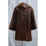 A Musquash fur ladies Coat: Size 10, full length.