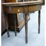 George III Demi Lune Card table: On turned cylindrical legs, height 76cm x width 79cm and depth 39.