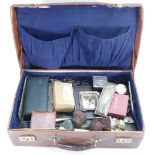A leather Suitcase containing various vintage collectables including silver jewellery,