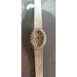 Omega ladies 18ct white gold & diamond oval ladies mechanical wrist watch: Complete with 18ct white