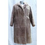 A blonde Musquash fur ladies Coat: Size 12, full length.