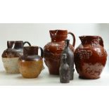 A collection of early Stoneware embossed Jugs and Flasks: Six items, tallest 30.
