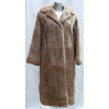 A Musquash fur ladies Coat: Size 12, full length.