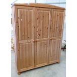 Pine three door wardrobe: with shelving cupboard.