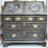 18th century Oak Bureau: With later Jacobean style carving, height 99cm x width 91cm and depth 53cm.