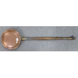 A copper warming pan with turned beech handle: