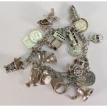 Silver charm bracelet with 19 charms, 56.4 grams.