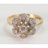 14ct gold and diamond cluster ring: The centre stone measuring about 20 points or 1/5th of a carat.