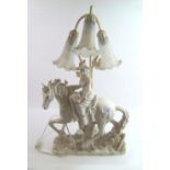 A large resin table lamp: in the form of a lady riding a horse on saddle back. Height 69cm