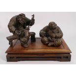 Japanese 1920 Bronze Figure Group on hardwood stand: height seated on stand 25cm