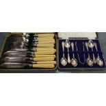 Silver cased teaspoons and sugar tongs: Silver weight 123.