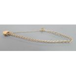 9ct gold hallmarked padlock bracelet: Dainty piece weighing 3g, about 17.5cm wearable length.