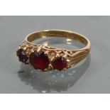 9ct gold ladies ring set with three garnets: size L, 2.3 grams.