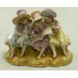 A large ceramic Continental style figure group: of girls seating on bench reading. Height 23cm