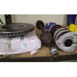 A quantity of mixed car parts: including brake discs and suspension parts.