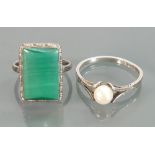 Silver ladies dress rings: one with pearl size Q and the other with oblong green stone size K/L.