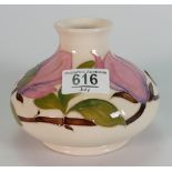 Moorcroft squat vase decorated in the magnolia design: height 11cm.