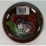 Moorcroft small round footed dish decorated in the hibiscus design: diameter 11,5cm.