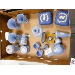 A collection of Wedgwood Jasper Ware items to include: lidded boxes, vases, candlestick,