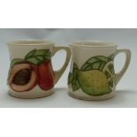 Moorcroft Mugs: Decorated with peaches and limes.