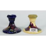 Two Walter Moorcroft Candlesticks: patterned Anemone on Blue Ground & Clematis on Yellow Ground(2)