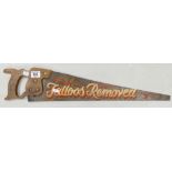 Decorative saw: painted with 'Tattoos removed'