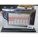 A vintage metal and wooden desk top calendar: