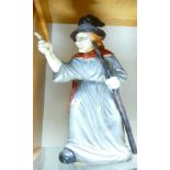 A large terracotta painted garden ornament of a witch: height 53cm