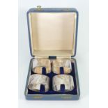 A set of four Silver serviette rings: decorated with game birds in original box,