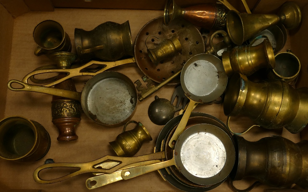 A collection of brass ware items to include: Goblets, frying pans,