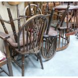 Seven wheel backed pub chairs: