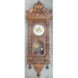 Early 20th century carved Walnut Spring Driven Wall clock: Height 120cm,