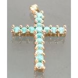 18ct gold crucifix pendant: The pendant set with turquoise stones, 5 grams.