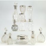 A collection of silver topped glass ware item to include: Silver topped scent bottles, vases,