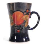 William Moorcroft tankard: Decorated in the Pomegranate design, height 12.5cm.