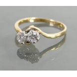 18ct gold ladies two stone crossover diamond ring: Approx .20ct each stone, size R, 3 grams.